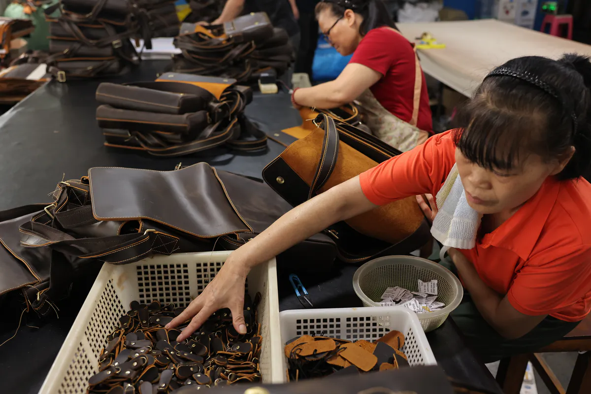 Hardware components being selected for leather bag production