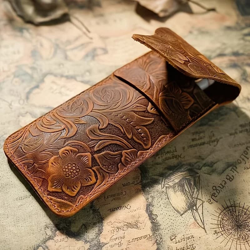 Two listed sizes of style Q1010 embossed leather pen sleeve shown open and closed