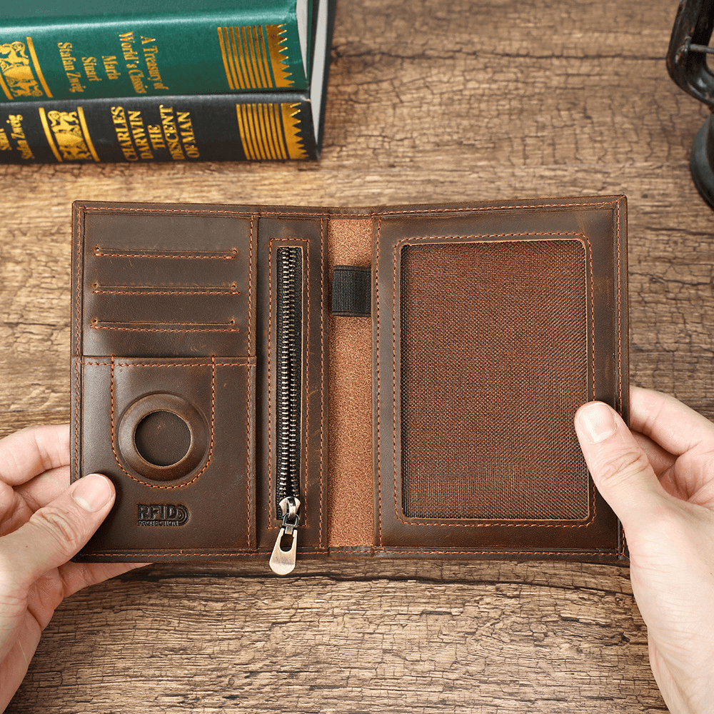 Brown leather passport wallet interior with AirTag slot, RFID protection, card slots and zip pocket